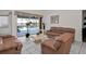 Cozy living room featuring white tile flooring, light colored walls, and leather furniture at 5194 Fleming St, Port Charlotte, FL 33981