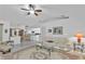 Bright living room with tile floors, white sofa, and open layout leading to the kitchen and dining areas at 5194 Fleming St, Port Charlotte, FL 33981