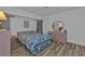 Cozy main bedroom with floral bedding, wood-look floors, and a ceiling fan at 5194 Fleming St, Port Charlotte, FL 33981