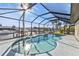 Sparkling pool with a safety rail inside a screened enclosure, providing canal views and sunshine at 5194 Fleming St, Port Charlotte, FL 33981