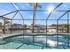 The screened pool features a beautiful view of the canal at 5194 Fleming St, Port Charlotte, FL 33981