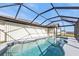 Sparkling pool inside a screened enclosure, providing canal views and sunshine at 5194 Fleming St, Port Charlotte, FL 33981