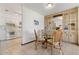 Bright dining area with glass table and wicker chairs, adjacent to kitchen at 520 Boardman Dr, Punta Gorda, FL 33950