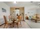 Dining area with glass-top table and wicker chairs adjacent to living room at 520 Boardman Dr, Punta Gorda, FL 33950