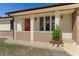 Front view of a ranch home with a red door and brick facade at 520 Boardman Dr, Punta Gorda, FL 33950