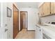 View down a hallway, with access to the laundry room and other areas at 520 Boardman Dr, Punta Gorda, FL 33950