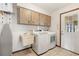 Laundry room with washer, dryer, utility sink, and cabinets at 520 Boardman Dr, Punta Gorda, FL 33950