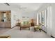 Living room featuring a light green accent chair and glass-top coffee table at 520 Boardman Dr, Punta Gorda, FL 33950