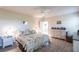 Bedroom with floral bedding, dresser and ceiling fan at 5277 Shell Mound Cir, Punta Gorda, FL 33982