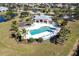 Aerial view of community pool with lounge chairs and surrounding landscape at 5277 Shell Mound Cir, Punta Gorda, FL 33982