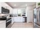 Modern kitchen with white cabinets, stainless steel appliances and an open layout at 5277 Shell Mound Cir, Punta Gorda, FL 33982