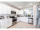 Modern kitchen with white cabinets, stainless steel appliances and quartz countertops at 5277 Shell Mound Cir, Punta Gorda, FL 33982