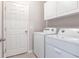 Laundry room with washer, dryer, cabinets and storage at 5277 Shell Mound Cir, Punta Gorda, FL 33982