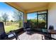 Relaxing screened porch with patio furniture and view of backyard at 5277 Shell Mound Cir, Punta Gorda, FL 33982