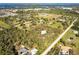 Aerial view of a house on a large lot with surrounding properties at 5301 Sabal Palm Ln, Punta Gorda, FL 33982