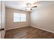 Spacious bedroom featuring wood-look floors and a ceiling fan at 5301 Sabal Palm Ln, Punta Gorda, FL 33982