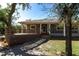 Gray house with wood deck and stone pathway, surrounded by lush trees at 5301 Sabal Palm Ln, Punta Gorda, FL 33982