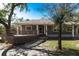 Gray house with wood deck and stone pathway, surrounded by lush trees at 5301 Sabal Palm Ln, Punta Gorda, FL 33982