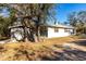 Side view of a single-story house with a shed and landscaping at 5301 Sabal Palm Ln, Punta Gorda, FL 33982