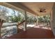 Covered porch with ceiling fan overlooking a wooded area at 5301 Sabal Palm Ln, Punta Gorda, FL 33982