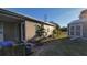 Mobile home with a large backyard, landscaping, and storage shed at 6671 Keystone Ct, North Port, FL 34287