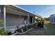 Exterior featuring covered porch and lovely landscaped yard at 6671 Keystone Ct, North Port, FL 34287