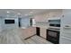 Open concept kitchen with stainless steel appliances and wood-look floors at 6671 Keystone Ct, North Port, FL 34287