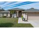 Tan two-story house with double doors and a two-car garage at 7543 S Blue Sage, Punta Gorda, FL 33955