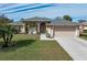 Single-story home with a two-car garage and landscaped lawn at 7543 S Blue Sage, Punta Gorda, FL 33955