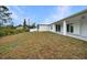 Large backyard with grassy area and covered patio at 85 Snedeker St, Port Charlotte, FL 33954