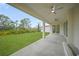 Covered patio with ceiling fans and views of the backyard at 85 Snedeker St, Port Charlotte, FL 33954