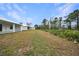 View of expansive backyard with grassy area and trees at 85 Snedeker St, Port Charlotte, FL 33954