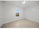 Simple bedroom with wood-look floors and a window at 85 Snedeker St, Port Charlotte, FL 33954