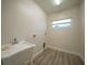 Laundry room with utility sink and light wood flooring at 85 Snedeker St, Port Charlotte, FL 33954