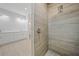 Walk-in shower with wood-look tile and modern fixtures at 85 Snedeker St, Port Charlotte, FL 33954