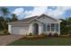 One-story home with a two-car garage and landscaping at 9534 Turtle Grass Cir, Punta Gorda, FL 33950