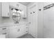 Stylish bathroom with white shaker cabinets and a round mirror at 121 Cambridge Nw Dr, Port Charlotte, FL 33952