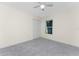 Well-lit bedroom featuring grey carpet and double door closet at 121 Cambridge Nw Dr, Port Charlotte, FL 33952