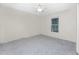 Bright bedroom with grey carpet and a window with blinds at 121 Cambridge Nw Dr, Port Charlotte, FL 33952