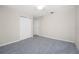 Cozy bedroom, featuring grey carpet and a ceiling fan at 121 Cambridge Nw Dr, Port Charlotte, FL 33952