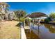 Wooden boat dock with covered lift on canal at 121 Cambridge Nw Dr, Port Charlotte, FL 33952