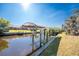 Covered boat lift with dock on a tranquil canal at 121 Cambridge Nw Dr, Port Charlotte, FL 33952