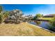 Landscaped yard with canal views and boat lift at 121 Cambridge Nw Dr, Port Charlotte, FL 33952