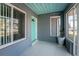 Enclosed porch with light teal door and tiled floor at 121 Cambridge Nw Dr, Port Charlotte, FL 33952