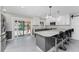 Modern kitchen with white and gray cabinets and breakfast bar at 121 Cambridge Nw Dr, Port Charlotte, FL 33952