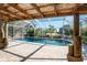 Inviting pool area with covered patio and lush landscaping at 121 Cambridge Nw Dr, Port Charlotte, FL 33952