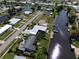 Aerial view of canal-front property and neighborhood at 136 Godfrey Ne Ave, Port Charlotte, FL 33952