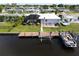 Aerial view of house, pool, dock, and boat on canal at 136 Godfrey Ne Ave, Port Charlotte, FL 33952