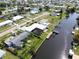 Large aerial showcasing the home's waterfront location at 136 Godfrey Ne Ave, Port Charlotte, FL 33952