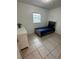 Bright bedroom with a single bed, dresser, and tile floors at 136 Godfrey Ne Ave, Port Charlotte, FL 33952